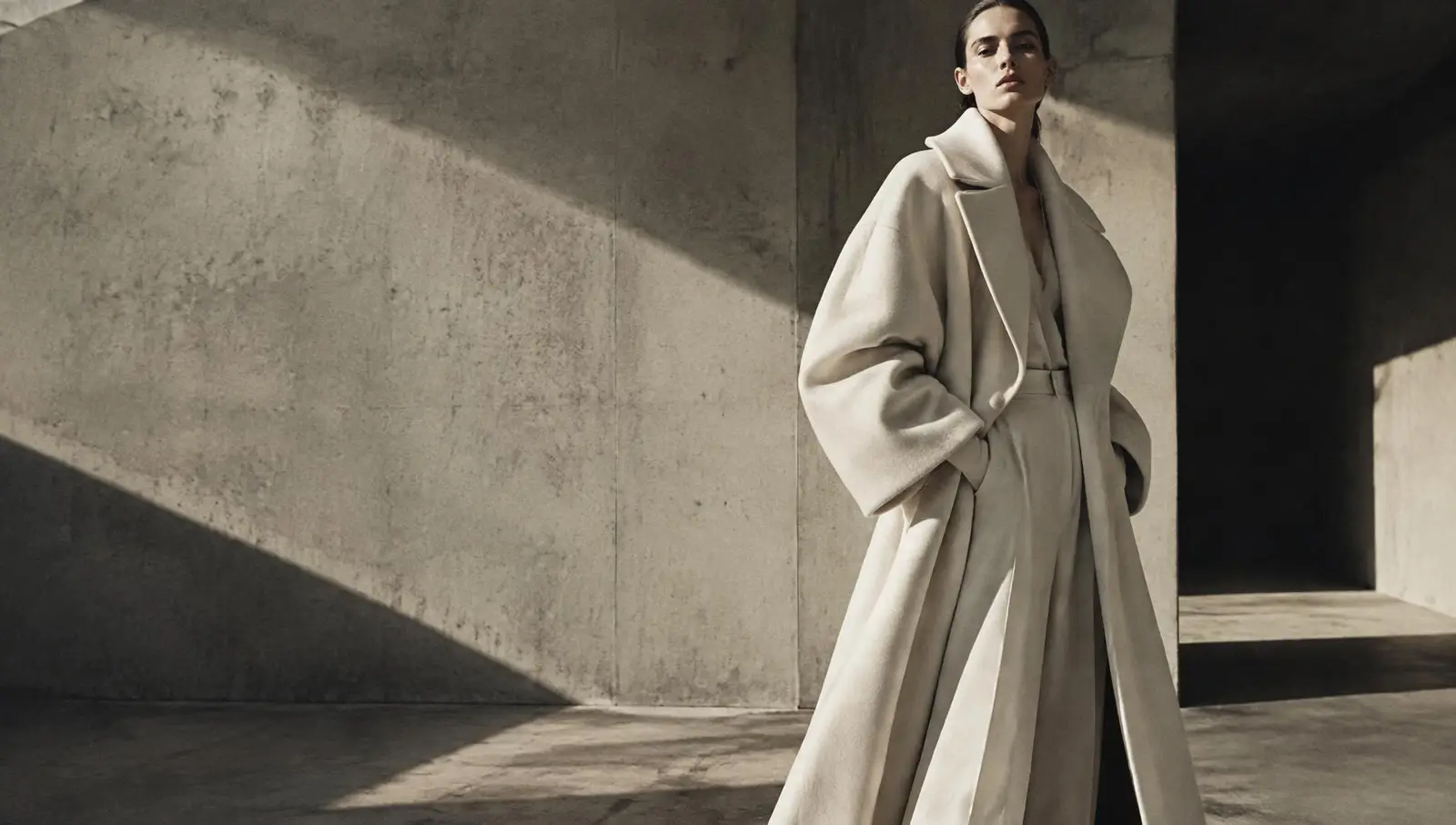 Fashion campaign — model in an oversized cream coat